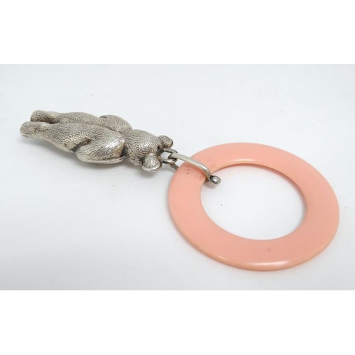 605 - A silver plated child's rattle formed as a bear with pink ivorine teething ring