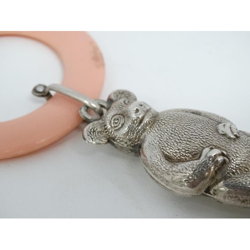 605 - A silver plated child's rattle formed as a bear with pink ivorine teething ring