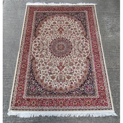 61 - Carpet / Rug :A beige ground Keshan style carpet measuring 63 1/2 x 96 1/2''