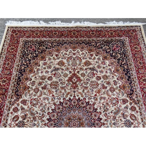 61 - Carpet / Rug :A beige ground Keshan style carpet measuring 63 1/2 x 96 1/2''