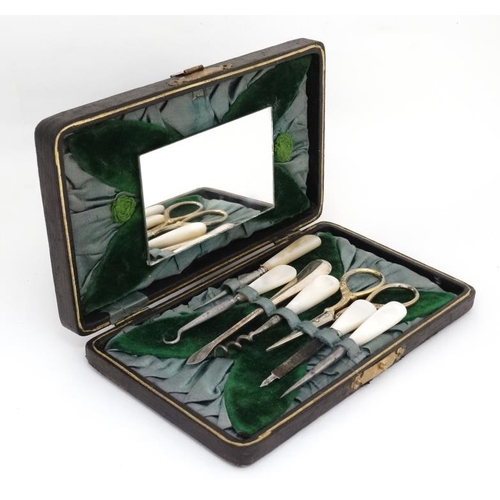 620 - Cased manicure items to include mother of pearl files, silver plate scissors etc. The case 7'' wide