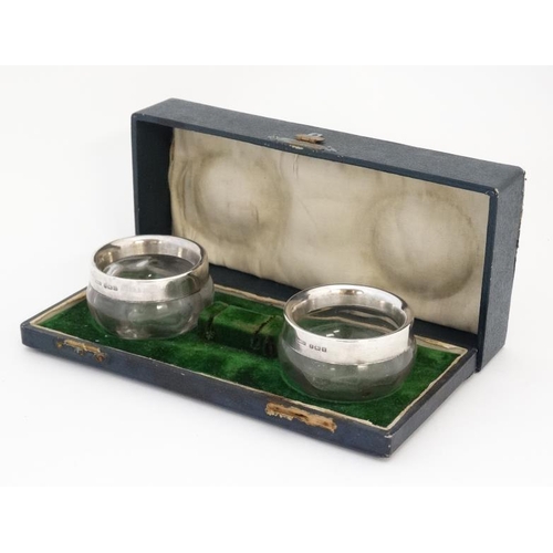 629 - A pair of glass salts with silver rims hallmarked 1907 maker A & J Zimmerman Ltd. 2'' diameter