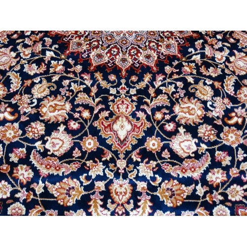 63 - Carpet / Rug : A machine made Keshan carpet, the blue and red ground with stylised floral motiffs. 6... 