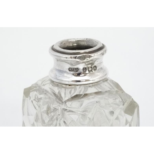 633 - A cut glass perfume bottle of square form with silver collar and faceted ball stopper. The collar ha... 