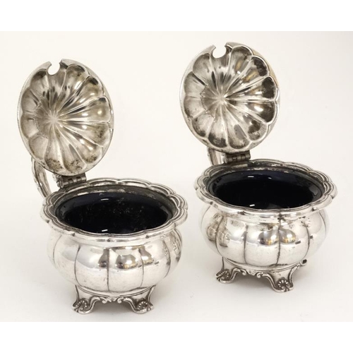 636 - A pair of silver plated mustard pots with hinged lids and blue glass liners 2 1/2'' high