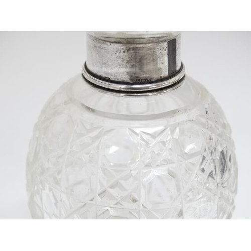 638 - A cut glass scent bottle with silver top. 3 3/4'' high