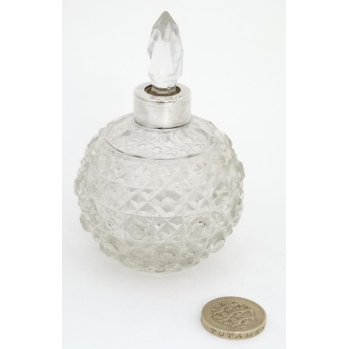 646 - A cut glass scent bottle of spherical form with white metal collar The whole 3 3/4''  high