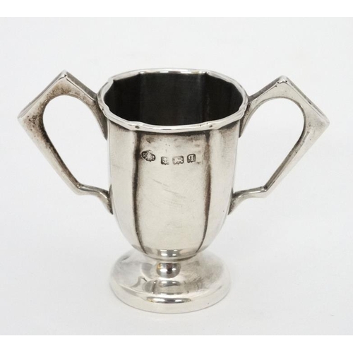 647 - A twin handled miniature trophy cup hallmarked Birmingham 1915 maker William Hutton & Sons Ltd. 2'' ... 