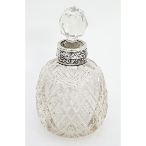 655 - A Victorian cut glass scent bottle with silver collar having engraved acanthus decoration hallmarked... 