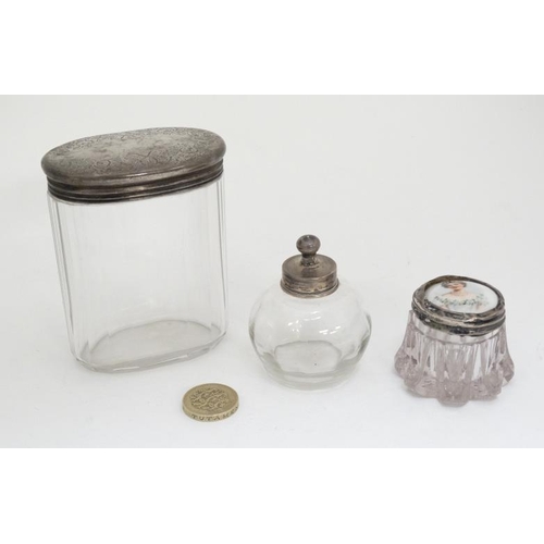 659 - 3 assorted glass dressing table pots with late 19thC / early 20thC silver tops (3)