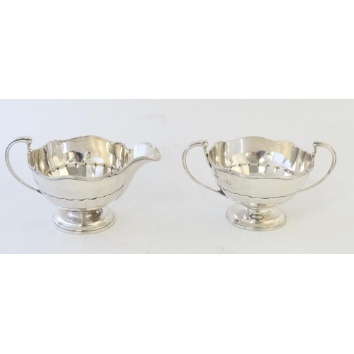 662 - A silver strawberry set comprising sugar bowl and cream jug. Hallmarked London 1911 maker maker Olli... 