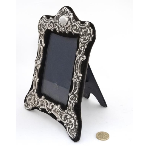 666 - An easel / strut photograph frame with silver border hallmarked London 1978 maker 8 1/4'' high overa... 