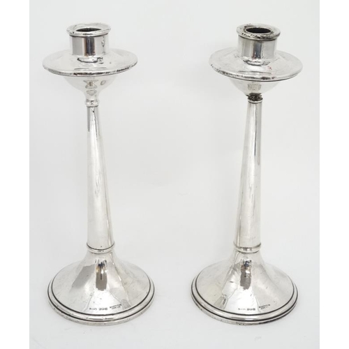 667 - A pair of silver candlesticks hallmarked Birmingham 1922 maker Cornelius Desormeaux Saunders & James... 