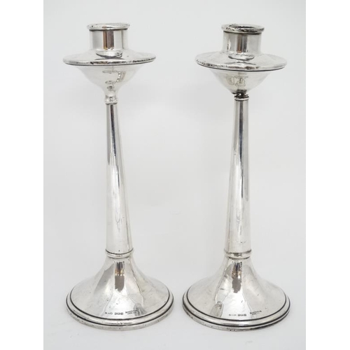 667 - A pair of silver candlesticks hallmarked Birmingham 1922 maker Cornelius Desormeaux Saunders & James... 