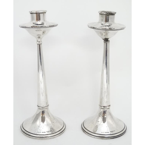 667 - A pair of silver candlesticks hallmarked Birmingham 1922 maker Cornelius Desormeaux Saunders & James... 