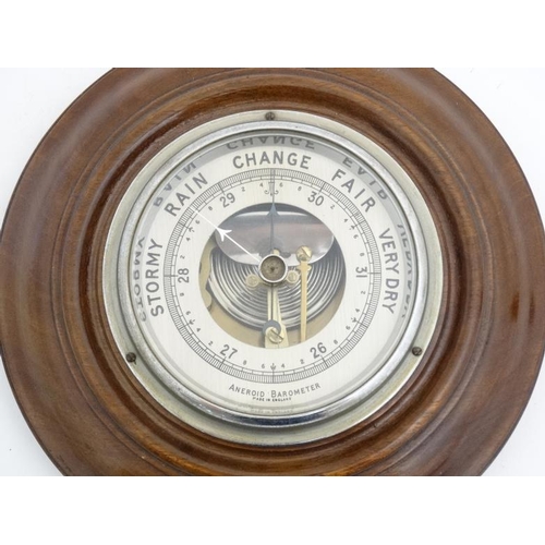 67 - Aneroid Barometer : an early- mid 20thC mahogany cased aneroid barometer with open workings, silvere... 