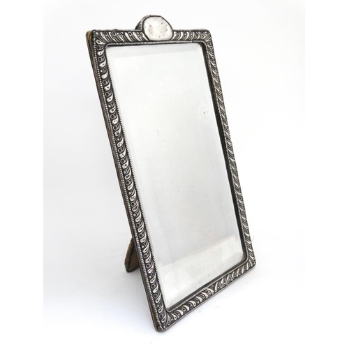 670 - A strut/ easel backed mirror with silver surround and central beveled mirror. Hallmarked Chester 190... 