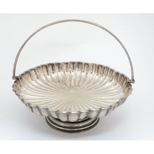 672 - A pedestal cake basket of lobed tazza form with swing  handle. approx 9 1/2'' diameter