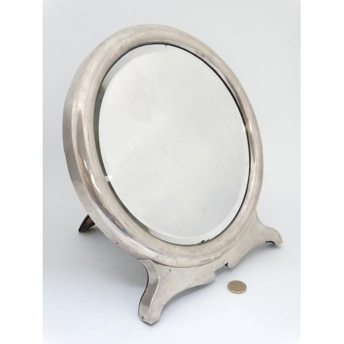 673 - A silver framed mirror with strutt / easel back and bevelled central circular mirror.  Hallmarked Lo... 