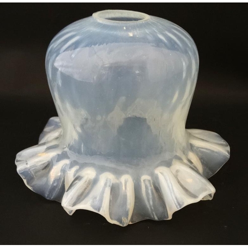 679 - A c.1900 vaseline glass lamp shade with fine netted design with frilled rim. Length 4 3/4''