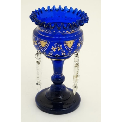 684 - A blue glass pedestal table lustre with gilt and enamel deocration, frilled rim  and lustre drops. 9... 