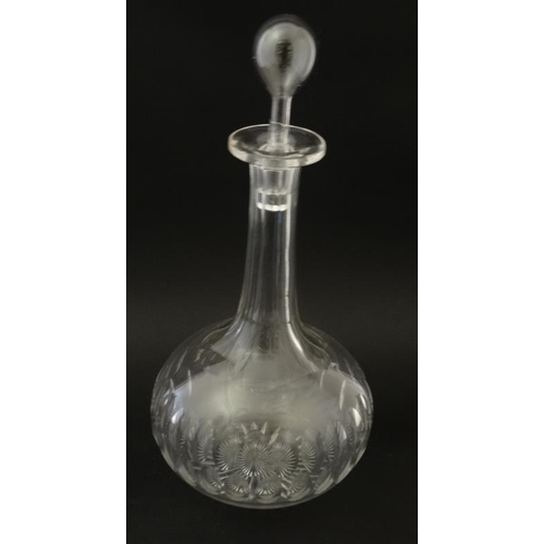 692 - A tall cut glass claret jug together with an onion shaped glass decanter with facet cut decoration. ... 