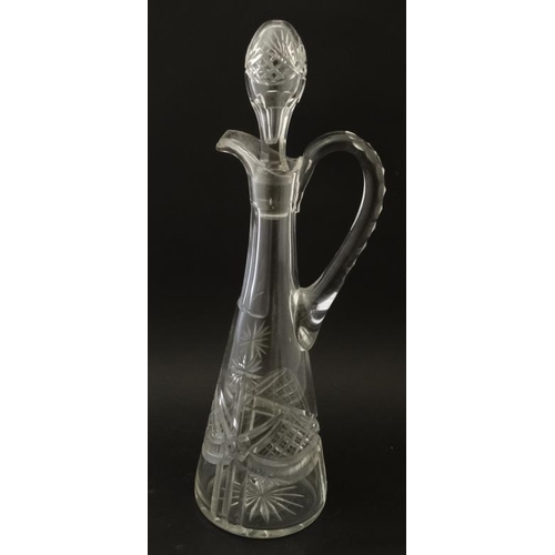 692 - A tall cut glass claret jug together with an onion shaped glass decanter with facet cut decoration. ... 