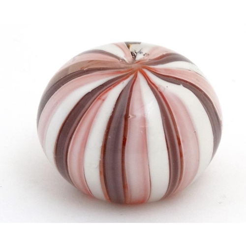 695 - A glass paperweight with banded pink and white decoration approx 3'' diameter