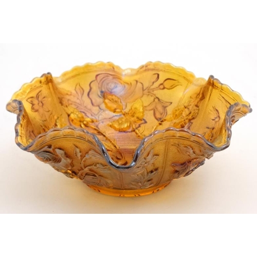 697 - Carnival glass : A Carnival glass bowl with rose pattern and flared rim 9'' diameter