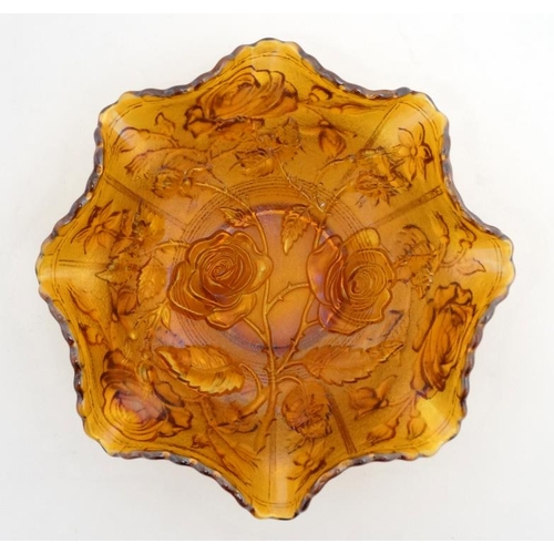 697 - Carnival glass : A Carnival glass bowl with rose pattern and flared rim 9'' diameter