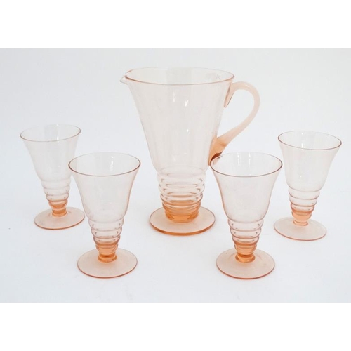 699 - Art Deco : a peach glass lemonade jug with four  matching glasses. The jug 9 1/2'' high