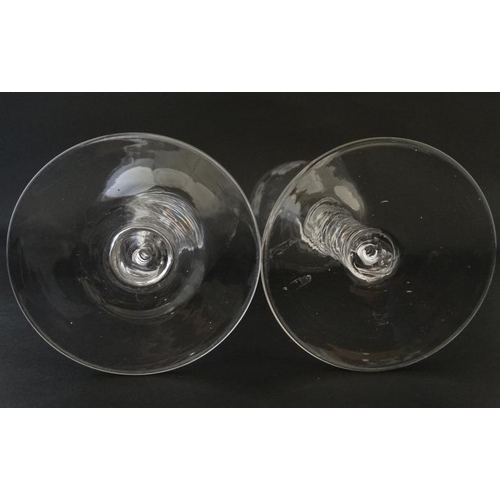 704 - A pair of large pedestal glasses with etched fruiting vine decoration and air twist detail to stems ... 