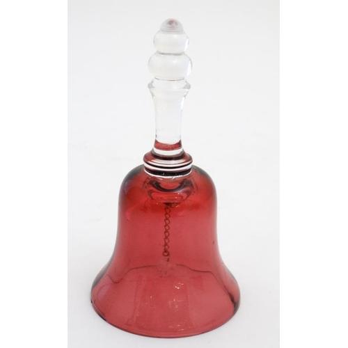 722 - Cranberry Glass : a quantity of glass wares including  2 jugs, bell and a caster. Tallest 6''