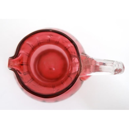 722 - Cranberry Glass : a quantity of glass wares including  2 jugs, bell and a caster. Tallest 6''