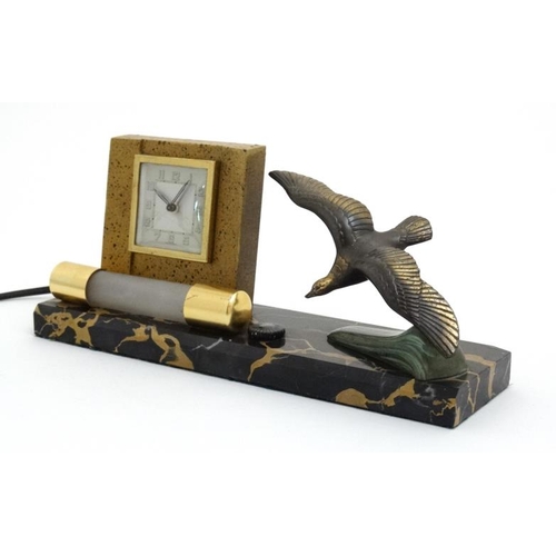 73 - Art Deco bedside light and clock : a French marble base with swooping sea bird and wind up clock hav... 