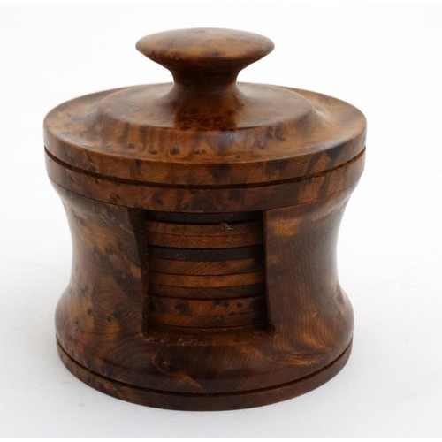 740 - 12 burr walnut coasters of cylindrical form within a cylindrical holder with lid. The coaster 3'' di... 