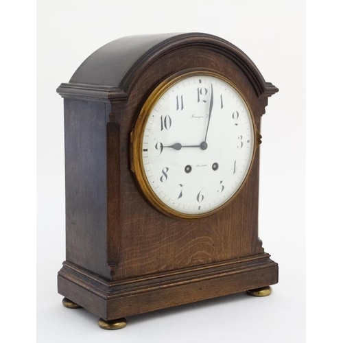 77 - Finnegans Ltd Manchester : an 8 day bracket Clock striking on a coiled gong in a Mahogany stained oa... 