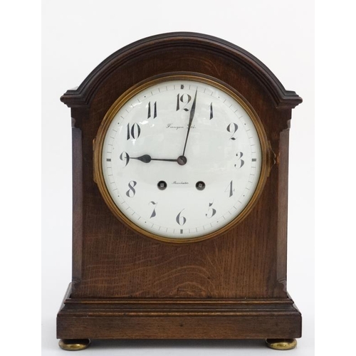 77 - Finnegans Ltd Manchester : an 8 day bracket Clock striking on a coiled gong in a Mahogany stained oa... 