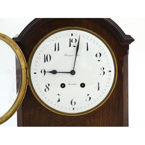 77 - Finnegans Ltd Manchester : an 8 day bracket Clock striking on a coiled gong in a Mahogany stained oa... 