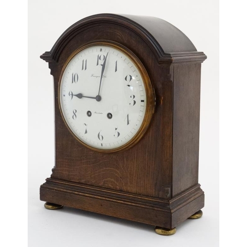 77 - Finnegans Ltd Manchester : an 8 day bracket Clock striking on a coiled gong in a Mahogany stained oa... 