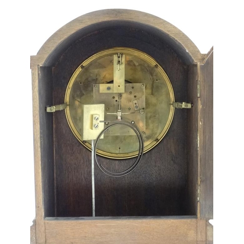 77 - Finnegans Ltd Manchester : an 8 day bracket Clock striking on a coiled gong in a Mahogany stained oa... 