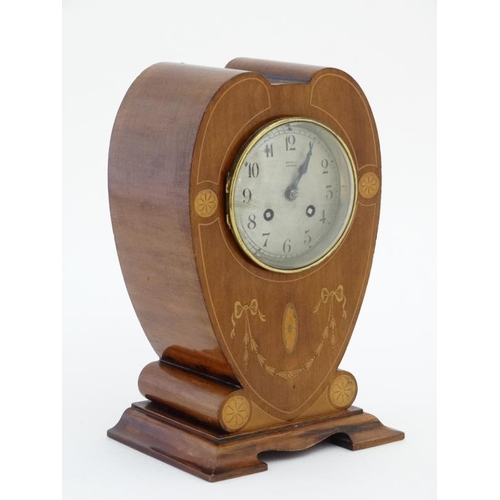 78 - Rowell Oxford : a signed Art Nouveau shaped case inlaid mahogany mantle clock, striking on a coiled ... 