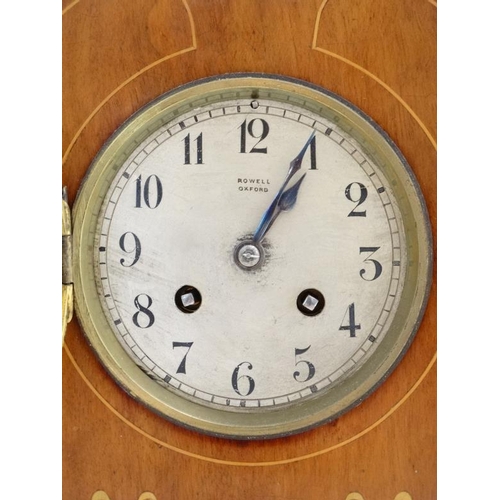 78 - Rowell Oxford : a signed Art Nouveau shaped case inlaid mahogany mantle clock, striking on a coiled ... 