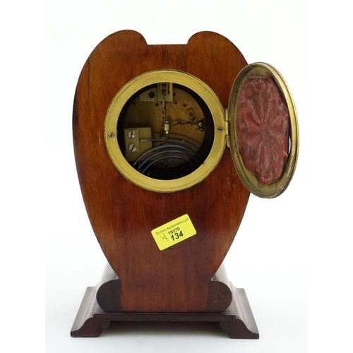 78 - Rowell Oxford : a signed Art Nouveau shaped case inlaid mahogany mantle clock, striking on a coiled ... 