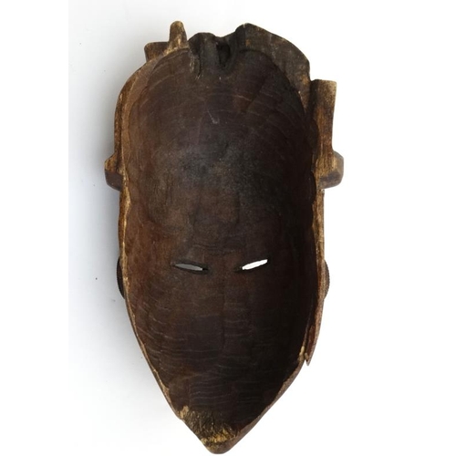 783 - Ethnographica : A Native Tribal :  an African carved wooden mask   With twisted wire decoration , 11... 