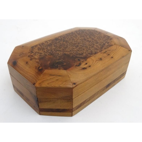 799 - A 20thC walnut box of octagonal form with burr wood decoration . 5 1/4'' x 8'' x 2 1/4''