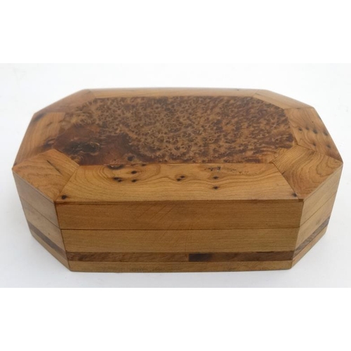 799 - A 20thC walnut box of octagonal form with burr wood decoration . 5 1/4'' x 8'' x 2 1/4''