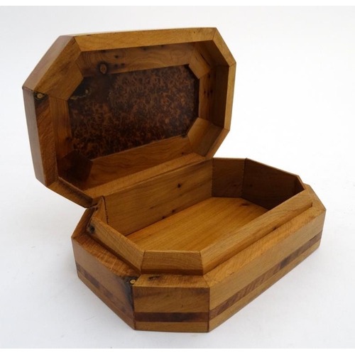 799 - A 20thC walnut box of octagonal form with burr wood decoration . 5 1/4'' x 8'' x 2 1/4''