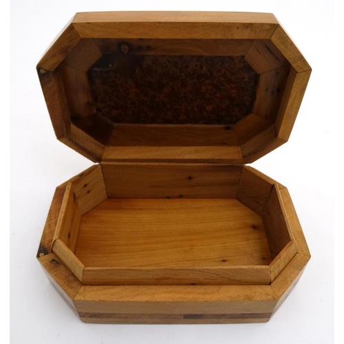 799 - A 20thC walnut box of octagonal form with burr wood decoration . 5 1/4'' x 8'' x 2 1/4''