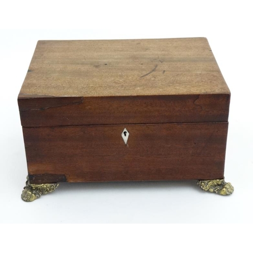 804 - A 19thC mahogany fitted box with  pressed brass handles and feet and opening to reveal fitted sectio... 